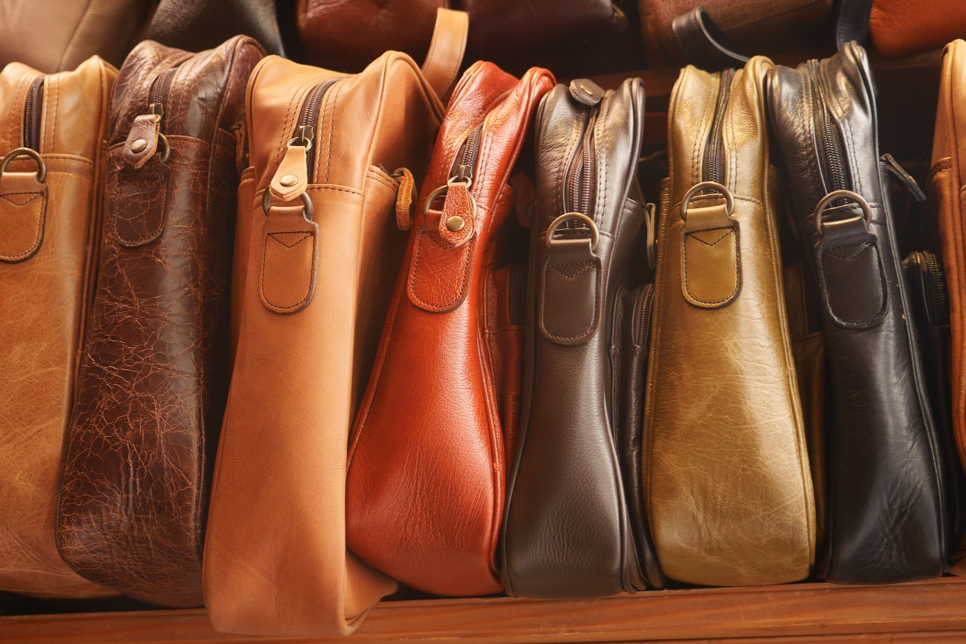 Close up of leather handmade bags on a wall for sale